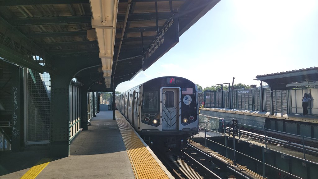 A J train arriving at the Woodhaven Boulevard station in Queens