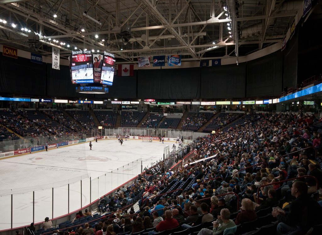 A crowd watches an AHL hockey game on the ice inside Albany's Times Union Center, now MVP Arena
