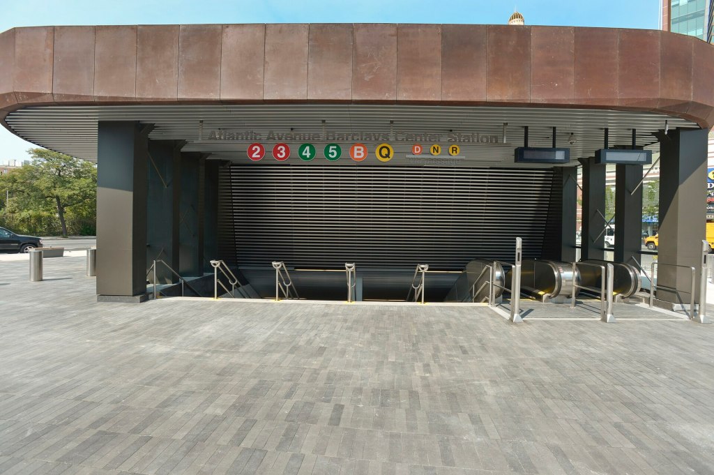 The subway entrance on the Barclays Center plaza, its canopy marked with the 2, 3, 4, 5, B, Q, D, N and R line bullets