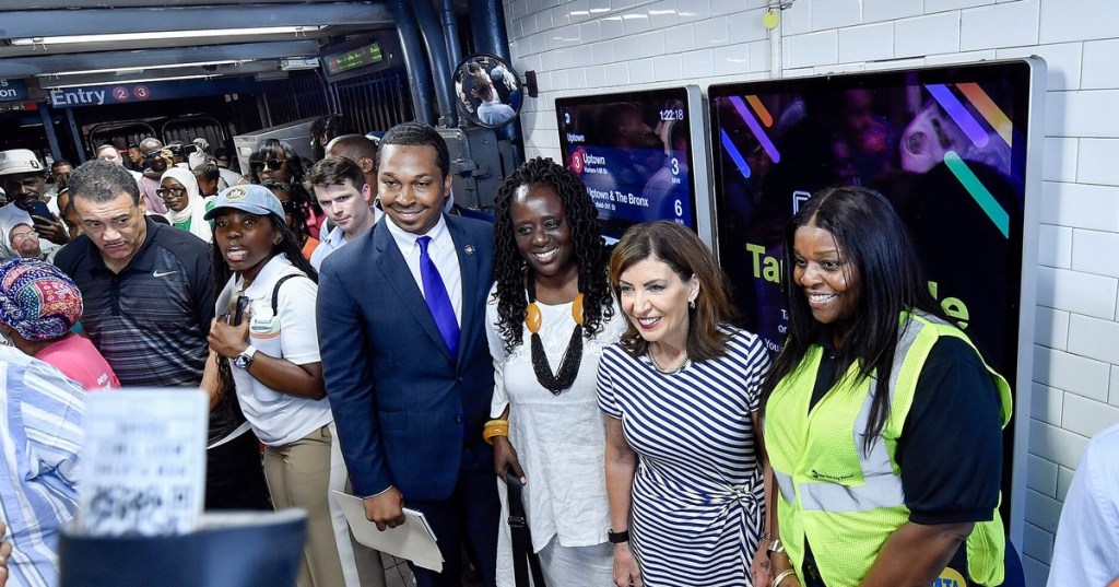 Gov. Kathy Hochul poses with Assembly Member Jordan J.G. Wright, State Senator Cordell Cleare and others inside the 110 St-Malcolm X Plaza subway station in Harlem, Aug. 10, 2025.