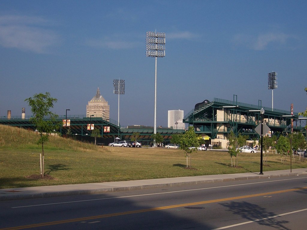 Rochester's soccer stadium and its light towers, with downtown Rochester's skyline behind it