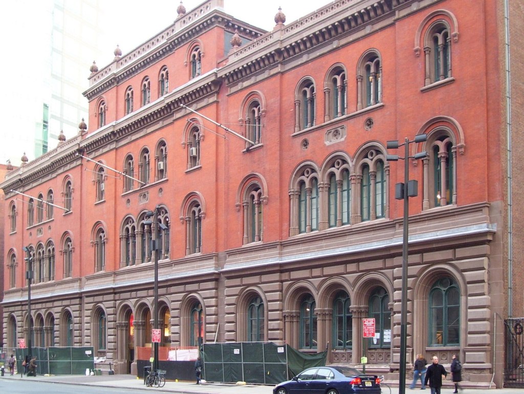 The red-brick and brownstone Romanesque Revival facade of the Public Theater, the former Astor Library, on Lafayette Street in Manhattan